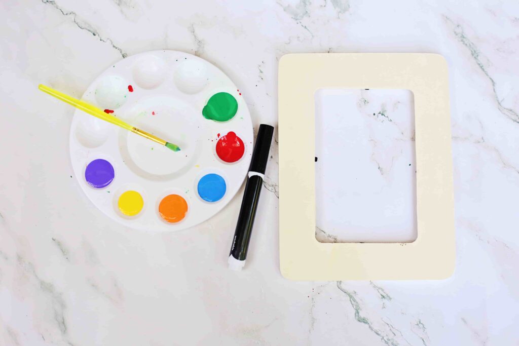 Fingerprint Christmas Lights Picture Frame - Cultivating Brilliant Minds supplies needed for the fingerprint picture frame - paint, a black marker, and a wooden picture frame