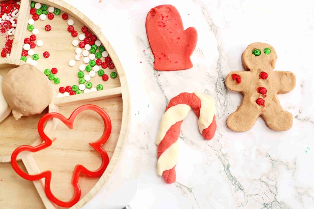 Holiday Cookie Playdough Bakery Tray - Cultivating Brilliant Minds a playdough tray filled with holiday-related items and playdough cookies
