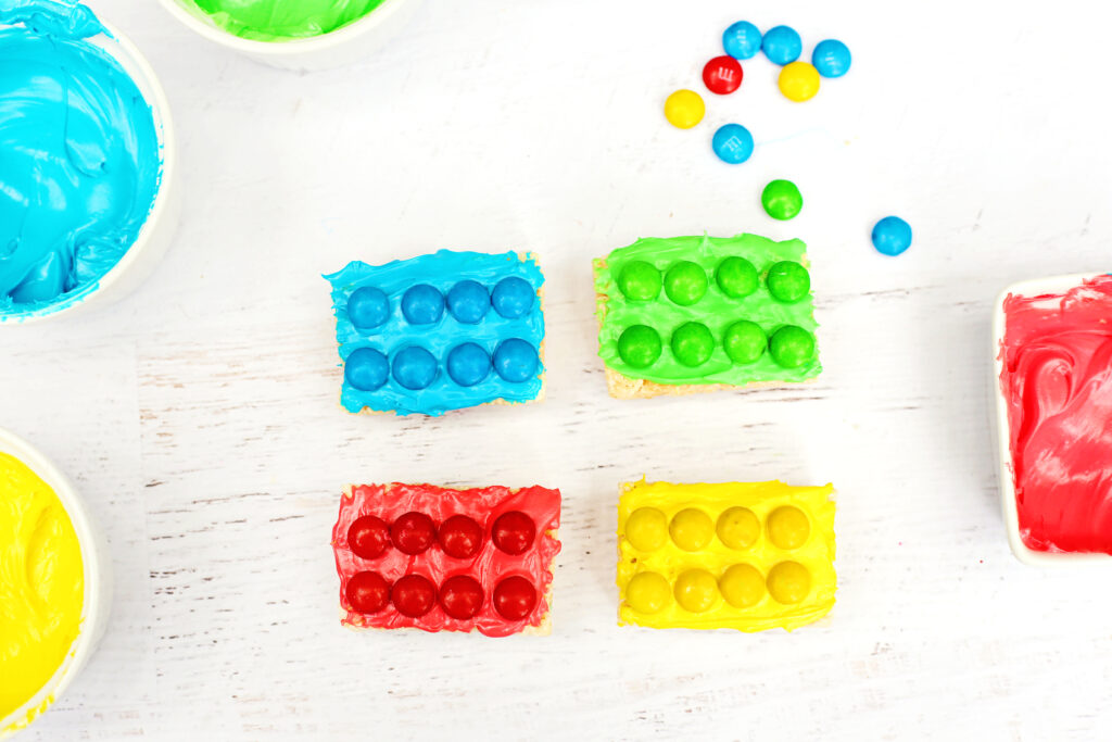 LEGO Rice Krispie Treats - Cultivating Brilliant Minds rice krispies with colored frosting and m&ms on top