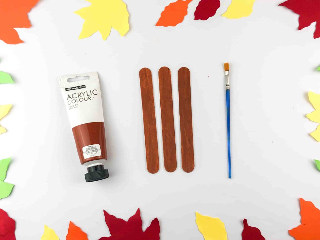 Thanksgiving Turkey Popsicle Stick Craft - Cultivating Brilliant Minds popsicle sticks painted brown