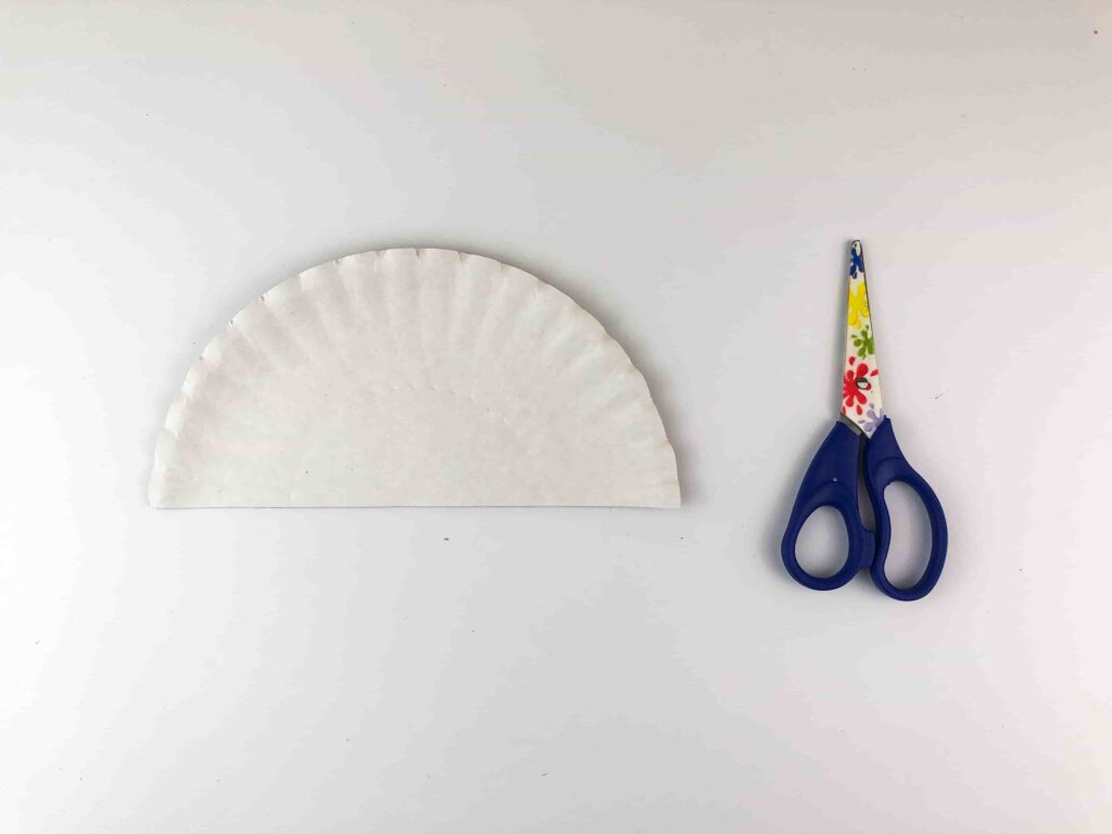 Thanksgiving Torn Paper Turkey Craft - Cultivating Brilliant Minds half of a paper plate with scissors next to it