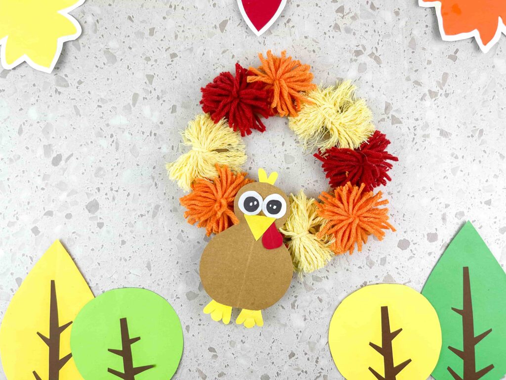 Thanksgiving Turkey Wreath Craft - Cultivating Brilliant Minds A thanksgiving turkey wreath craft using yarn