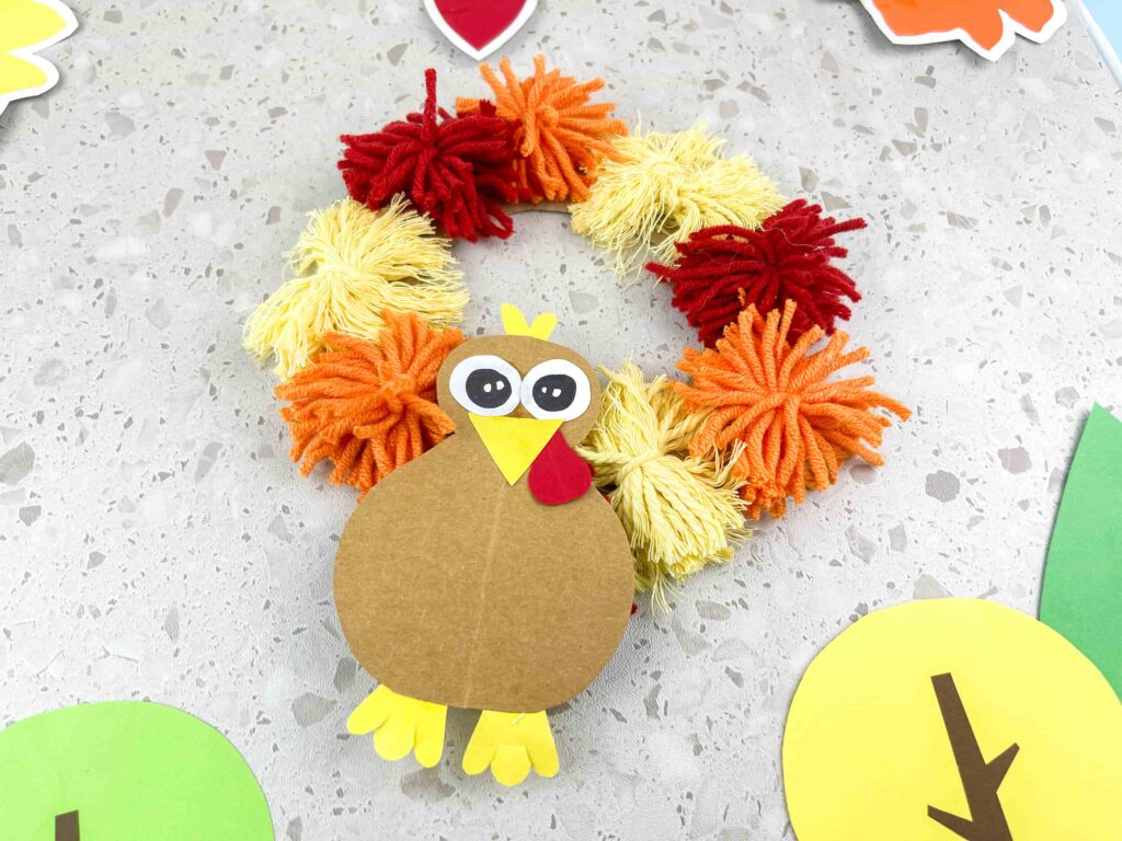 Thanksgiving Turkey Wreath Craft - Cultivating Brilliant Minds A thanksgiving turkey wreath craft using yarn