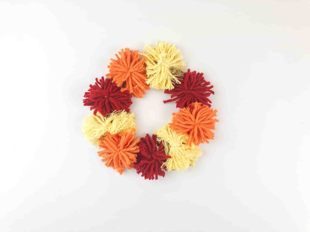 Thanksgiving Turkey Wreath Craft - Cultivating Brilliant Minds Wreath made of yarn pom poms