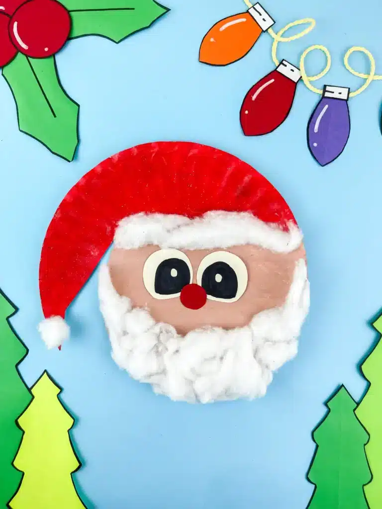 a paper plate painted and decorated to look like santa