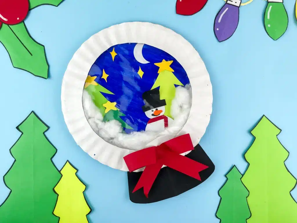 Snowglobe Paper Plate Craft - Cultivating Brilliant Minds a snowglobe paper plate craft that looks like a snowglobe with a snowman and trees inside