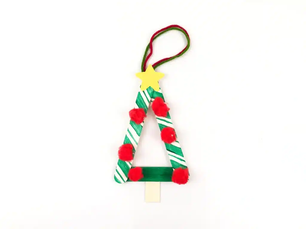 Christmas Tree Popsicle Stick Ornament - Cultivating Brilliant Minds a popsicle stick christmas ornament decorated to look like a tree