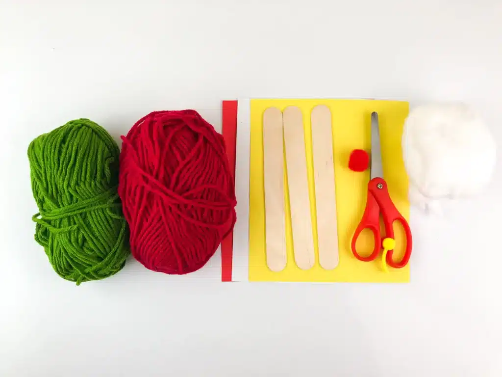 Santa Popsicle Stick Craft - Cultivating Brilliant Minds yarn, construction paper, cotton balls, red pom pom, scissors, and popsicle sticks