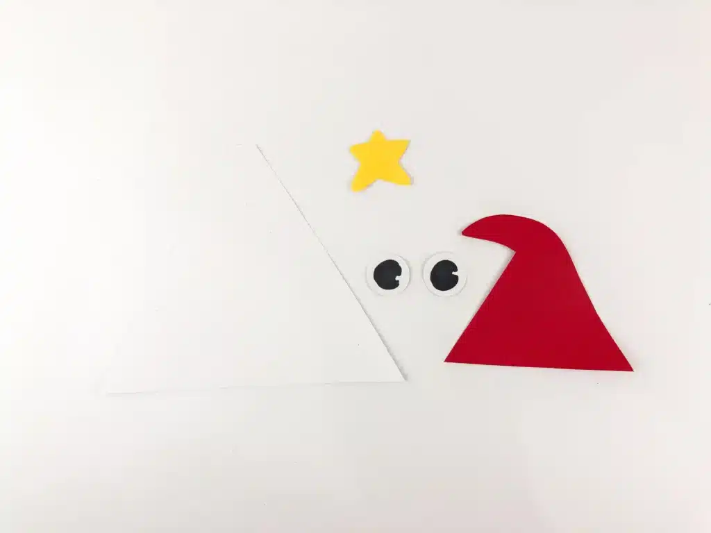 Santa Popsicle Stick Craft - Cultivating Brilliant Minds triangle, eyes, star, and santa hat cut out of construction paper