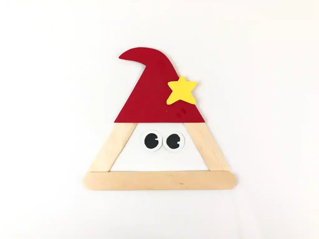 Santa Popsicle Stick Craft - Cultivating Brilliant Minds popsicle sticks glued into a triangle with a red hat, and eyes to look like santa