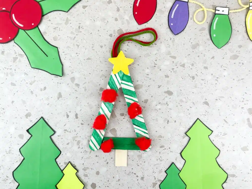 Christmas Tree Popsicle Stick Ornament - Cultivating Brilliant Minds a popsicle stick christmas ornament decorated to look like a tree