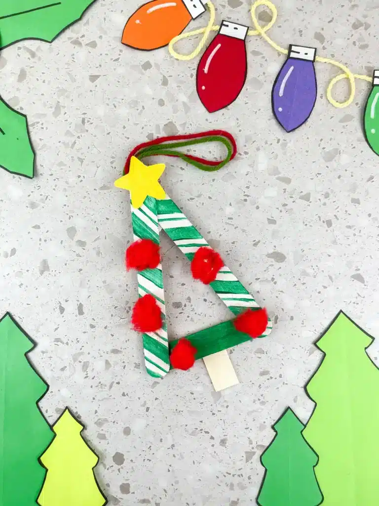 Christmas Tree Popsicle Stick Ornament - Cultivating Brilliant Minds a popsicle stick christmas ornament decorated to look like a tree
