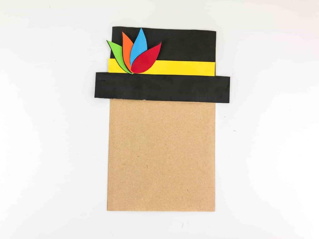 Thanksgiving Turkey Paper Bag Craft - Cultivating Brilliant Minds a brown paper bag with a construction paper hat on top