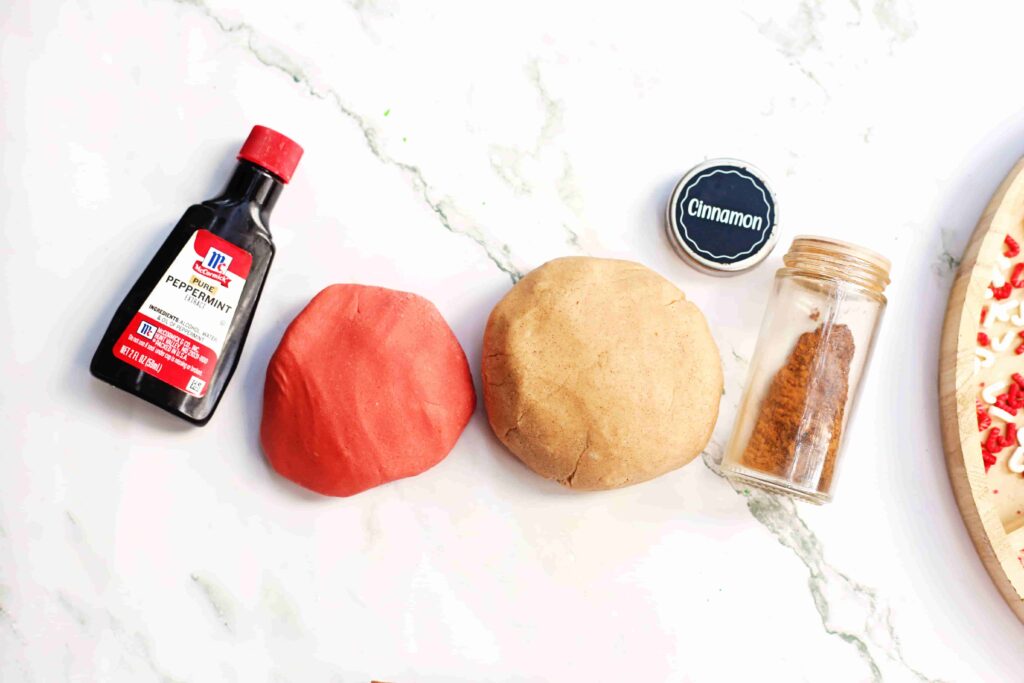 Holiday Cookie Playdough Bakery Tray - Cultivating Brilliant Minds playdough, red food coloring, and cinnamon