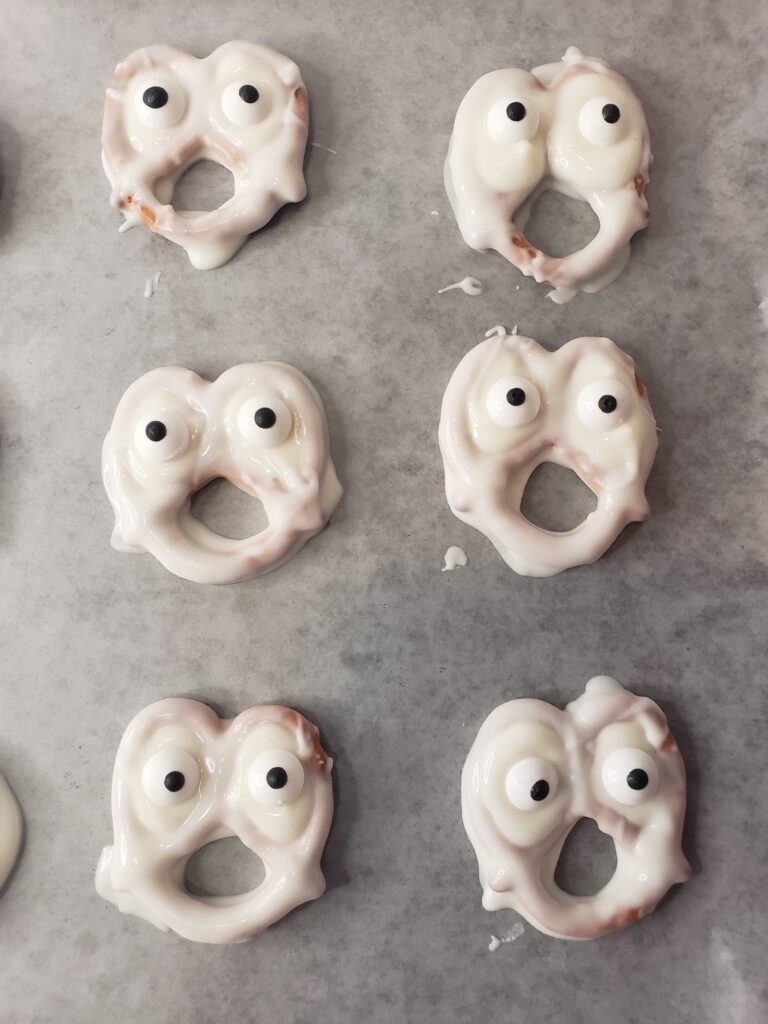 Ghost Pretzels For Halloween - Cultivating Brilliant Minds pretzels decorated to look like ghosts