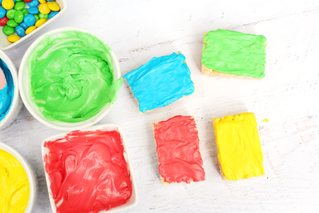 LEGO Rice Krispie Treats - Cultivating Brilliant Minds colored frosting spread on rice krispie treats