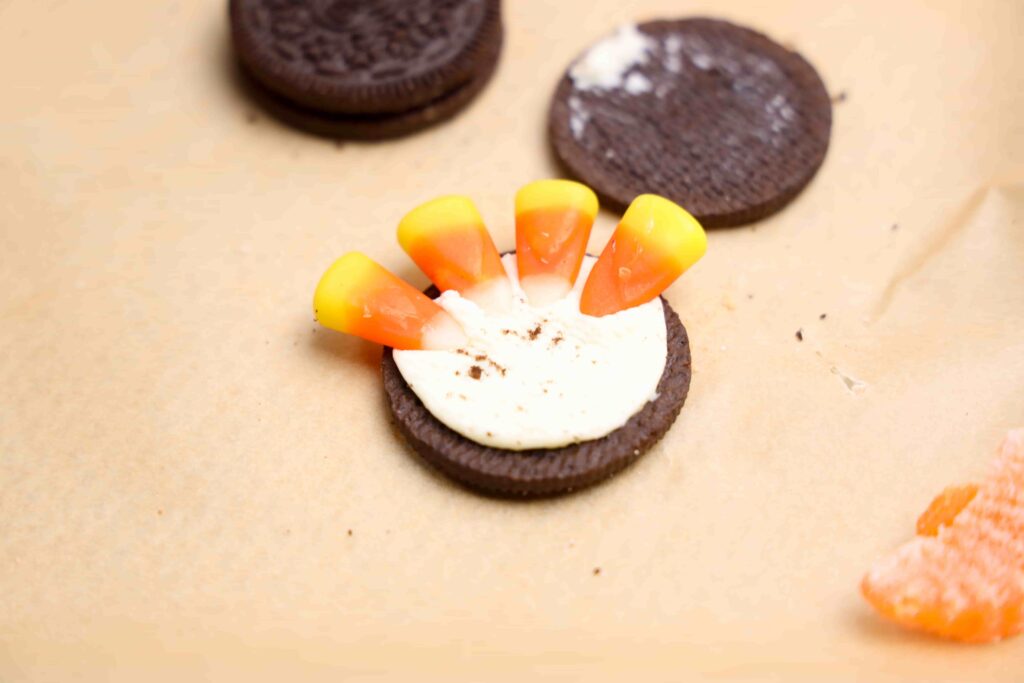 Turkey Oreos for Thanksgiving - Cultivating Brilliant Minds half an oreo cookie with candy corn on it