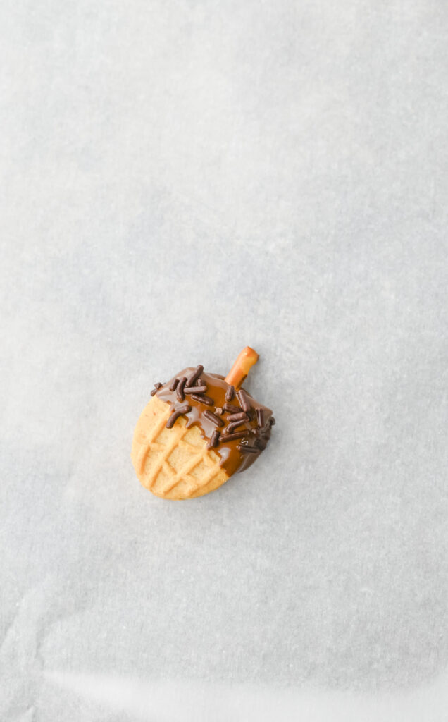 Nutter Butter Acorns - Cultivating Brilliant Minds Nutter Butter Acorns with a pretzel inserted in the top for a stem