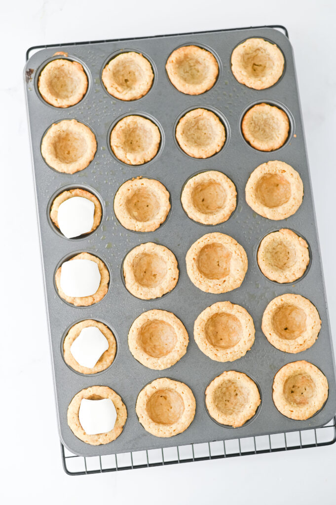 S'mores Cookie Cups - Cultivating Brilliant Minds cookie batter and marshmallow in a muffin pan