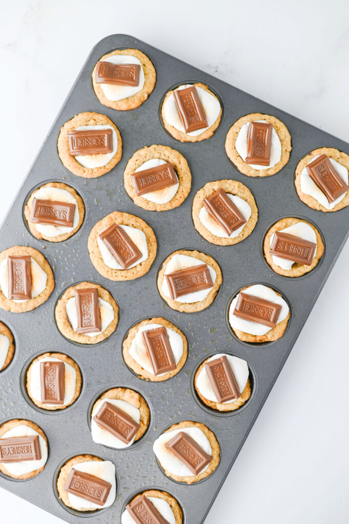 S'mores Cookie Cups - Cultivating Brilliant Minds cookie batter, chocolate, and marshmallow in a muffin pan