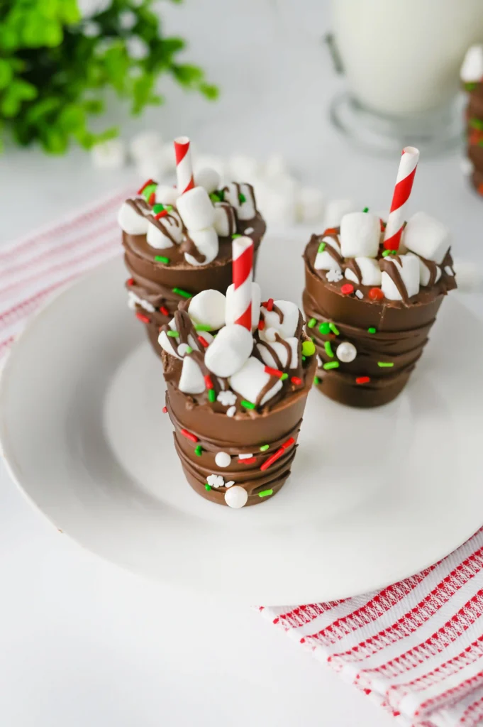 Hot Chocolate Sticks - Cultivating Brilliant Minds hot chocolate sticks with sprinkles and a red and white striped straw on a white plate