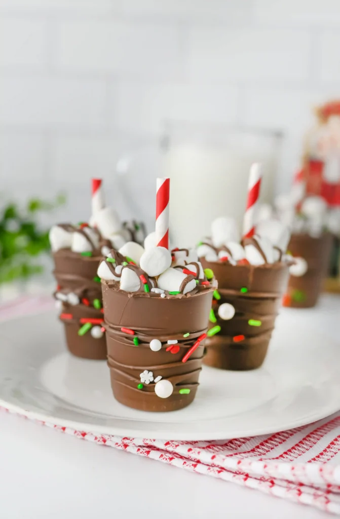 Hot Chocolate Sticks - Cultivating Brilliant Minds hot chocolate sticks with sprinkles and a red and white striped straw on a white plate