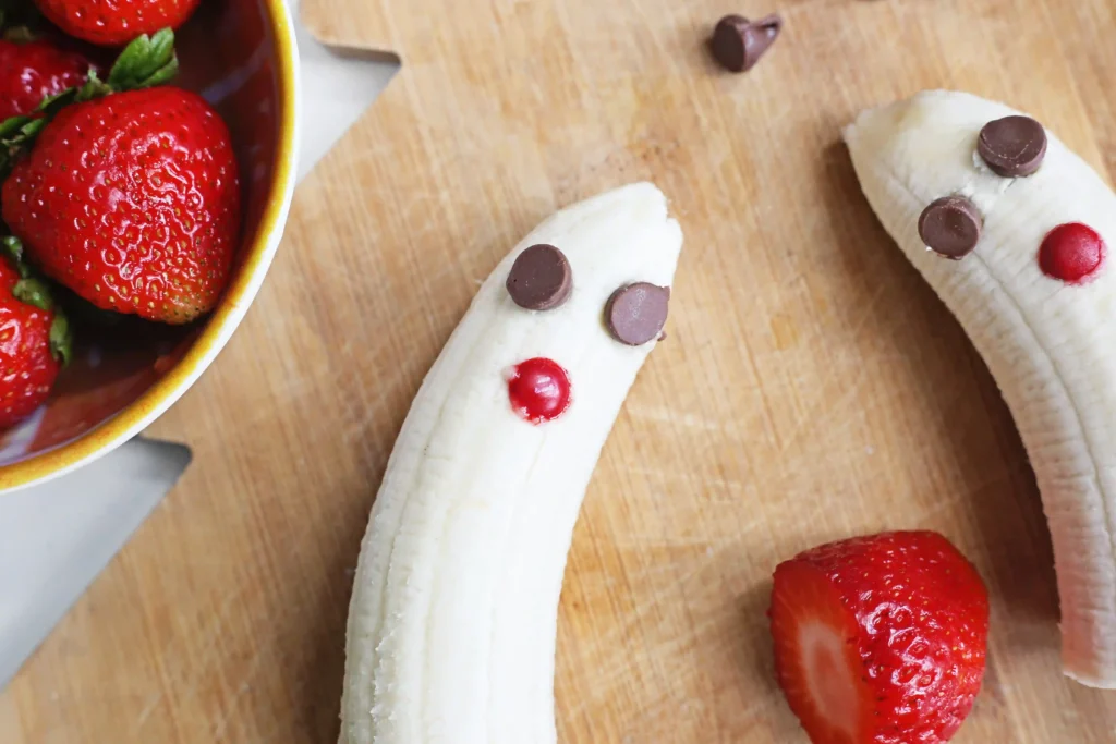 Banana Santa: A Healthy Christmas Snack - Cultivating Brilliant Minds bananas with chocolate chip eyes and an m&m for a mouth