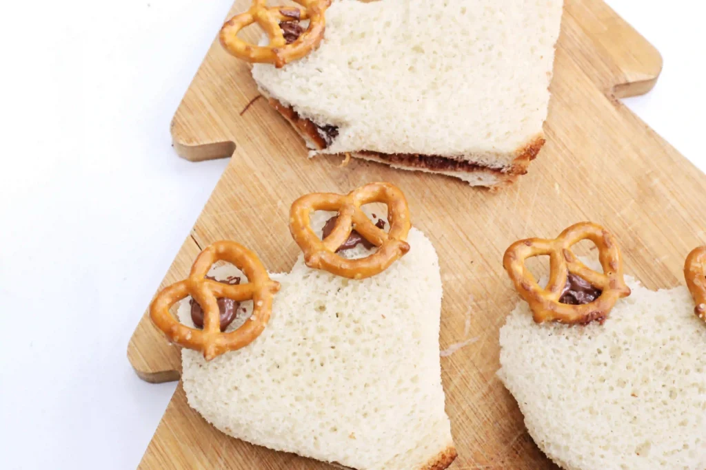 Nutella Reindeer Sandwiches - Cultivating Brilliant Minds sandwiches with pretzels on top to look like deer antlers