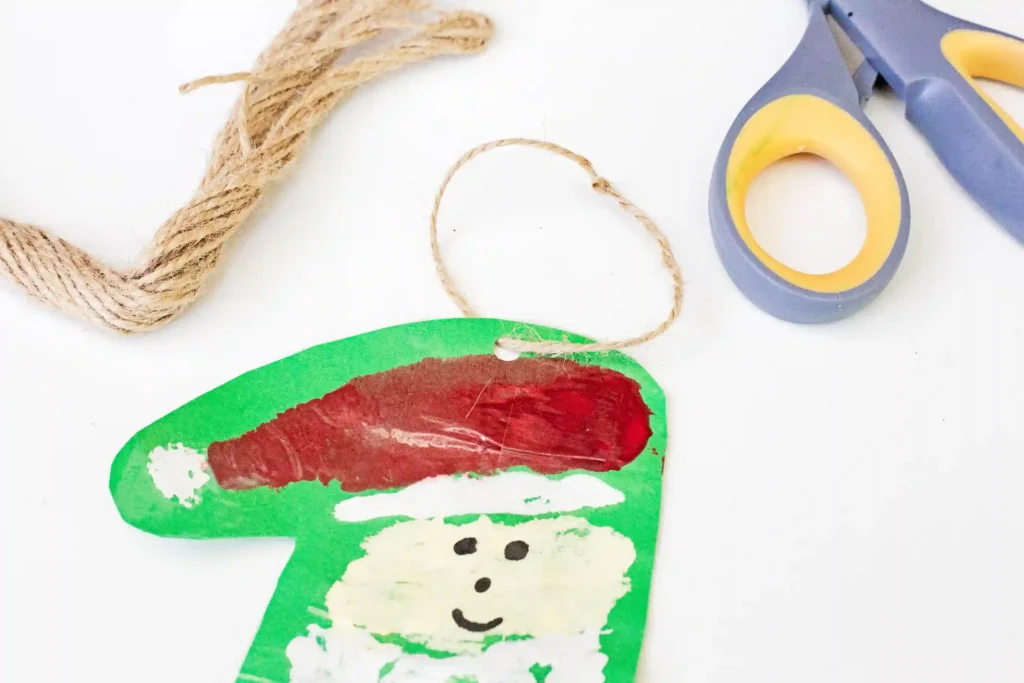 Handprint Santa Ornament - Cultivating Brilliant Minds a painted handprint craft made to look like santa