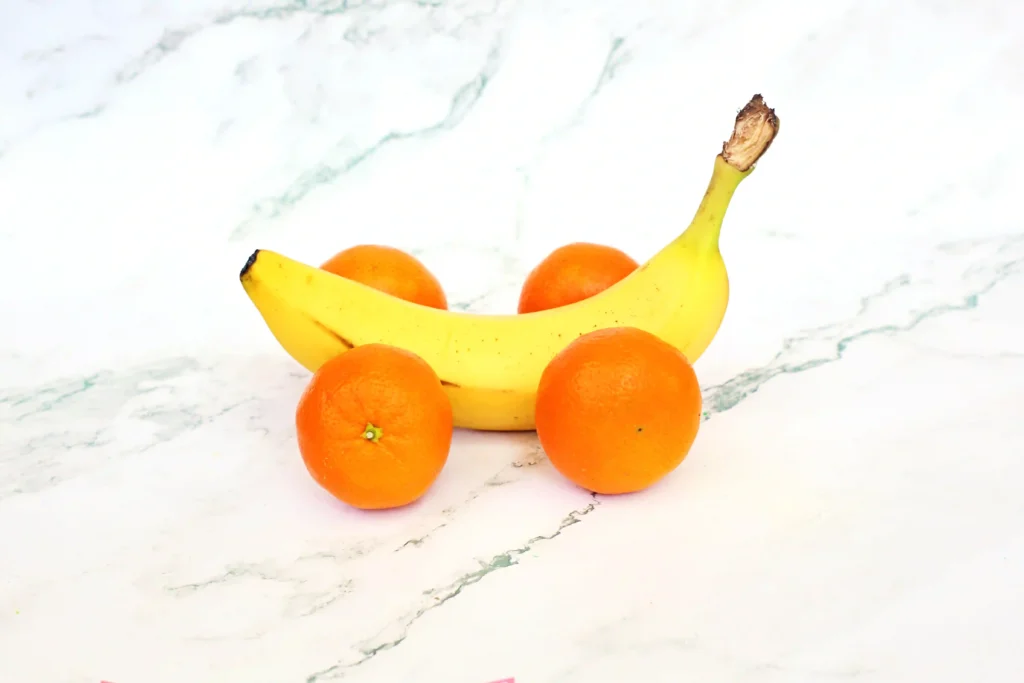 Elf on the Shelf Idea: Banana Races - Cultivating Brilliant Minds a banana made to look like a car with oranges for wheels