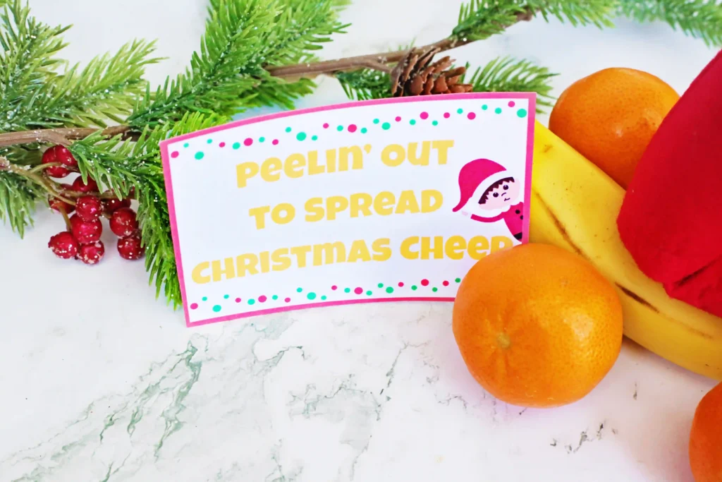 Elf on the Shelf Idea: Banana Races - Cultivating Brilliant Minds a sign that reads "peeling out for chirstmas cheer"