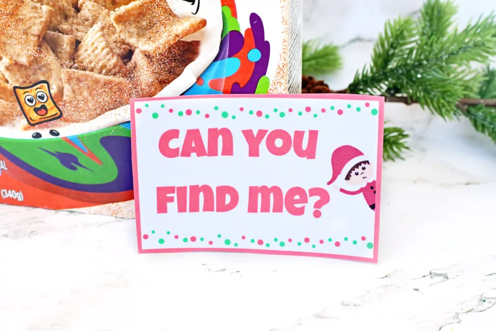 Elf on the Shelf Cereal Box Peekaboo - Cultivating Brilliant Minds a sign that reads "can you find me?" with a graphic of an elf on the shelf