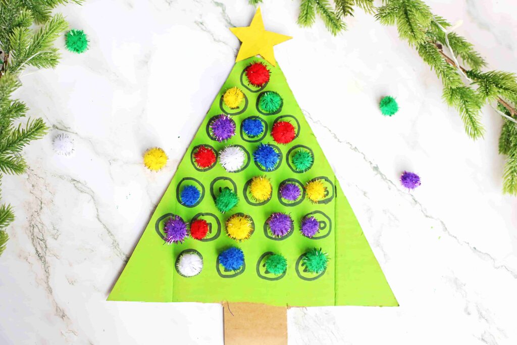 Christmas Tree Countdown Craft - Cultivating Brilliant Minds cardboard painted to look like a christmas tree with numbers on it. Pom poms are glued over some of the numbers