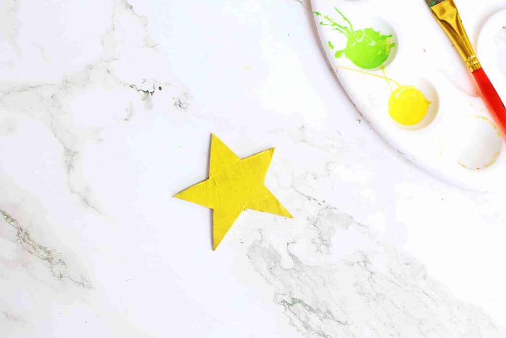 Christmas Tree Countdown Craft - Cultivating Brilliant Minds cardboard cut out and painted yellow to look like a star