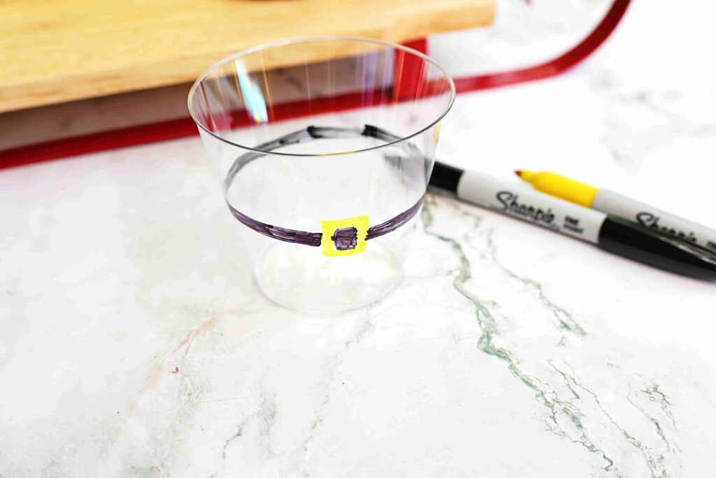 Santa Fruit Cups - Cultivating Brilliant Minds a plastic cup with a belt draw on