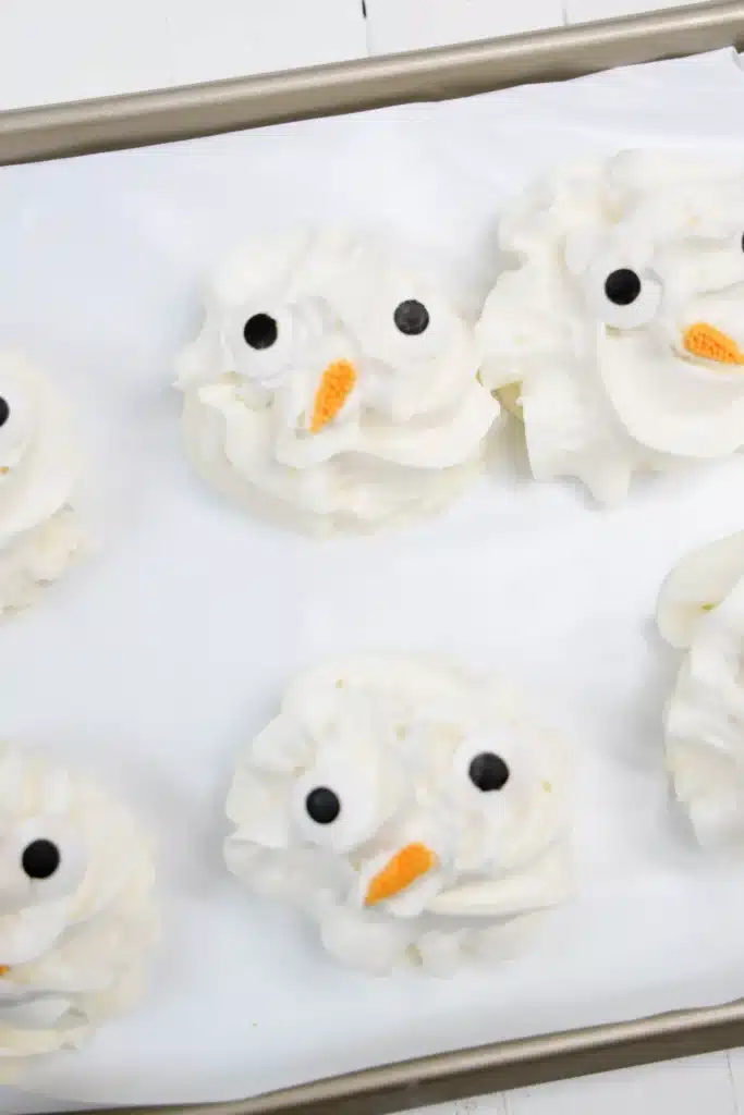 Frozen Whipped Cream Snowman - Cultivating Brilliant Minds frozen whipped cream with candy eyes and a carrot nose to look like a snowman