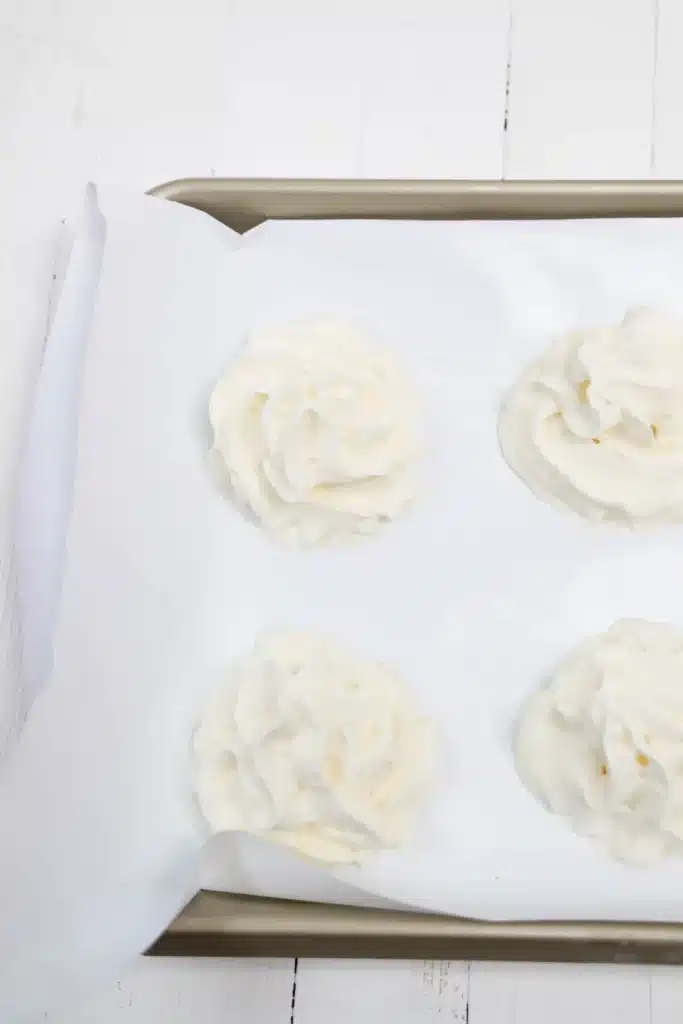 Frozen Whipped Cream Snowman - Cultivating Brilliant Minds whipped cream on parchment paper