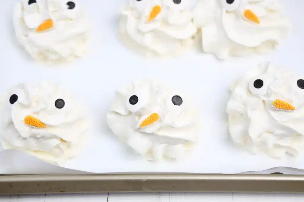 Frozen Whipped Cream Snowman - Cultivating Brilliant Minds frozen whipped cream with candy eyes and a carrot nose to look like a snowman
