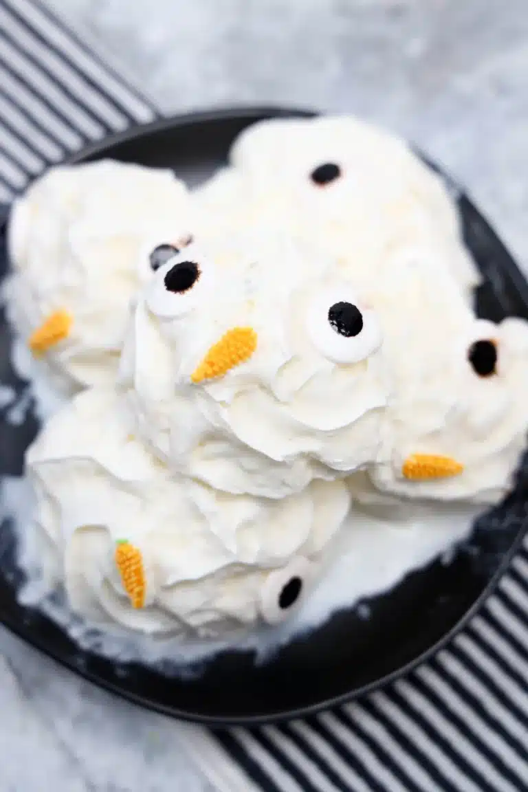 frozen whipped cream with candy eyes and a carrot nose to look like a snowman