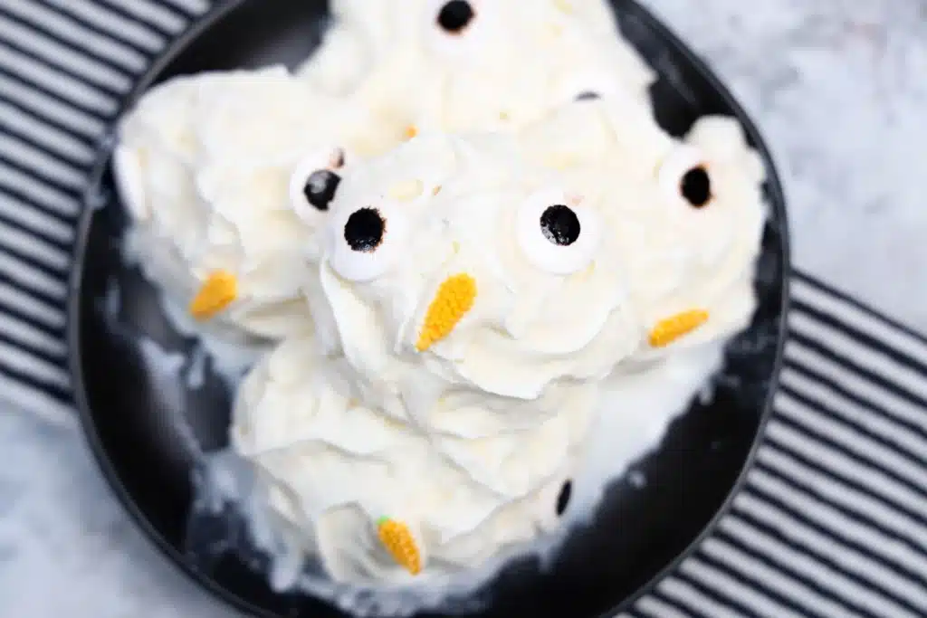 Frozen Whipped Cream Snowman - Cultivating Brilliant Minds frozen whipped cream with candy eyes and a carrot nose to look like a snowman