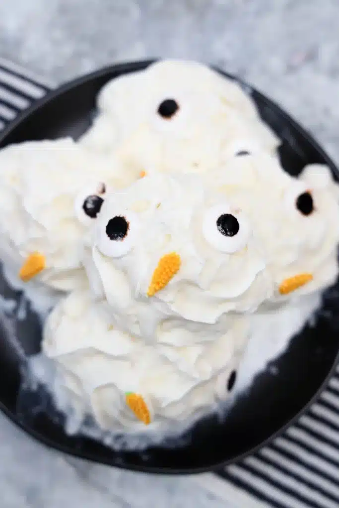 Frozen Whipped Cream Snowman - Cultivating Brilliant Minds frozen whipped cream with candy eyes and a carrot nose to look like a snowman