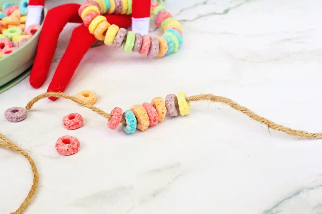 Elf on the Shelf Idea Fruit Loop Bracelets - Cultivating Brilliant Minds fruit loops strung on a string to make a bracelet