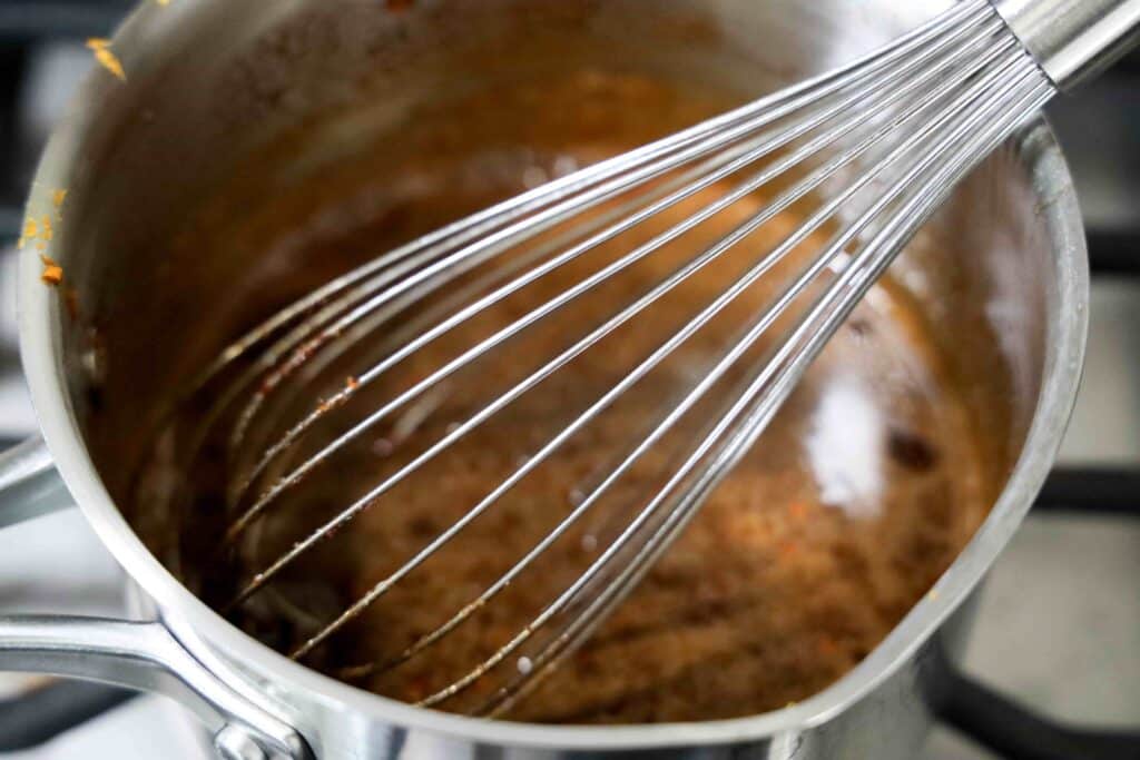 Grinch Gingerbread Cookies for Christmas - Cultivating Brilliant Minds whisk in a bowl