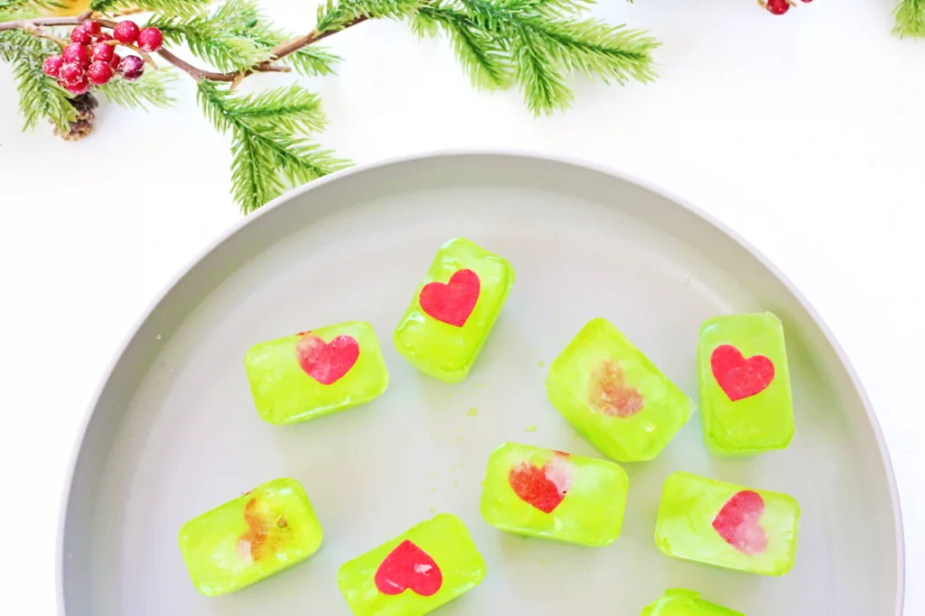 Grinch's Frozen Heart Activity - Cultivating Brilliant Minds melted green ice cubes with red hearts