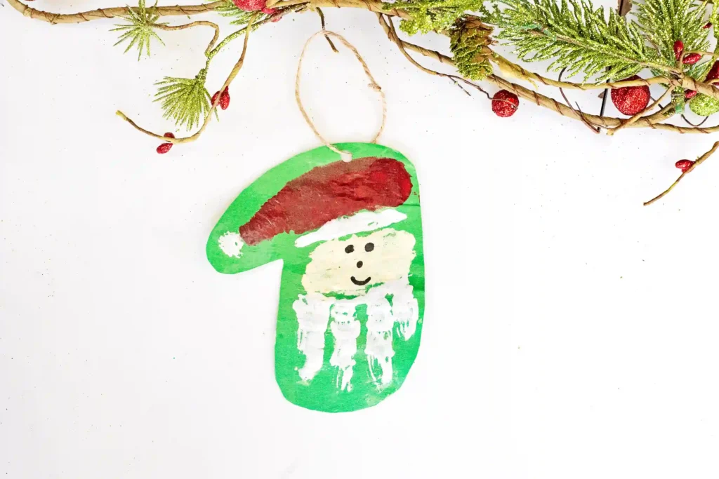 Handprint Santa Ornament - Cultivating Brilliant Minds a painted handprint craft made to look like santa