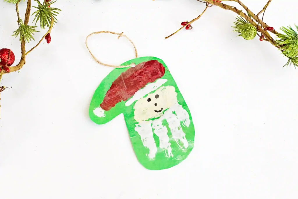 Handprint Santa Ornament - Cultivating Brilliant Minds a painted handprint craft made to look like santa