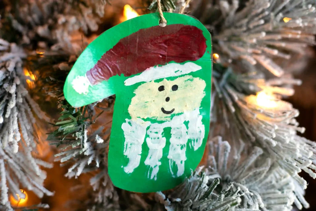 Handprint Santa Ornament - Cultivating Brilliant Minds a painted handprint craft made to look like santa