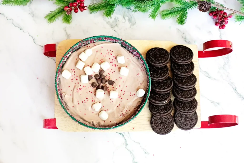 Hot Cocoa Dip - Cultivating Brilliant Minds hot cocoa dip with marshmallows in a green bowl next to oreos