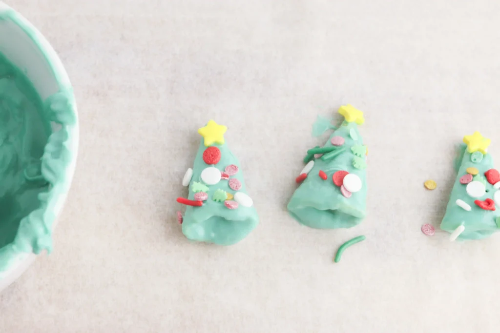 Christmas Tree Bugles - Cultivating Brilliant Minds bugles covered in green melted chocolate and sprinkles to look like christmas trees