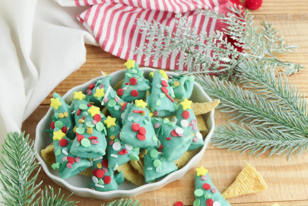 Christmas Tree Bugles - Cultivating Brilliant Minds bugles covered in green melted chocolate and sprinkles to look like christmas trees